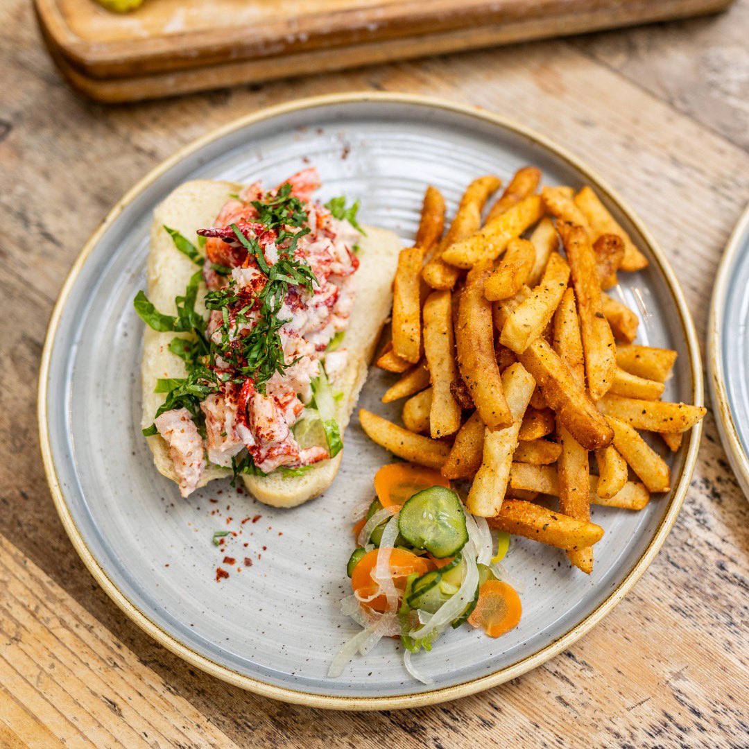 Dive into a taste of Miami's vibrant flavors with the Little Haiti Lobster Roll at @RoosterOvertown. It's infused with ginger lime mayo, topped with refreshing cucumber pikliz, and nestled in a buttered brioche bun.