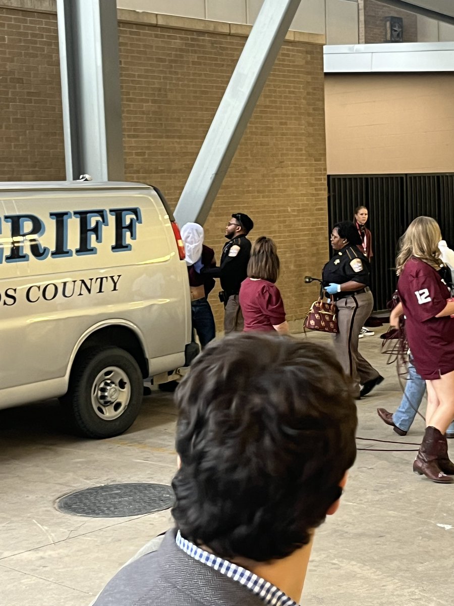 RossDellenger's tweet photo. Brazos County Sheriff deputies have just loaded into a van a man handcuffed with his head bagged from Kyle Field.
College football. https://t.co/qLDtZmtRUN