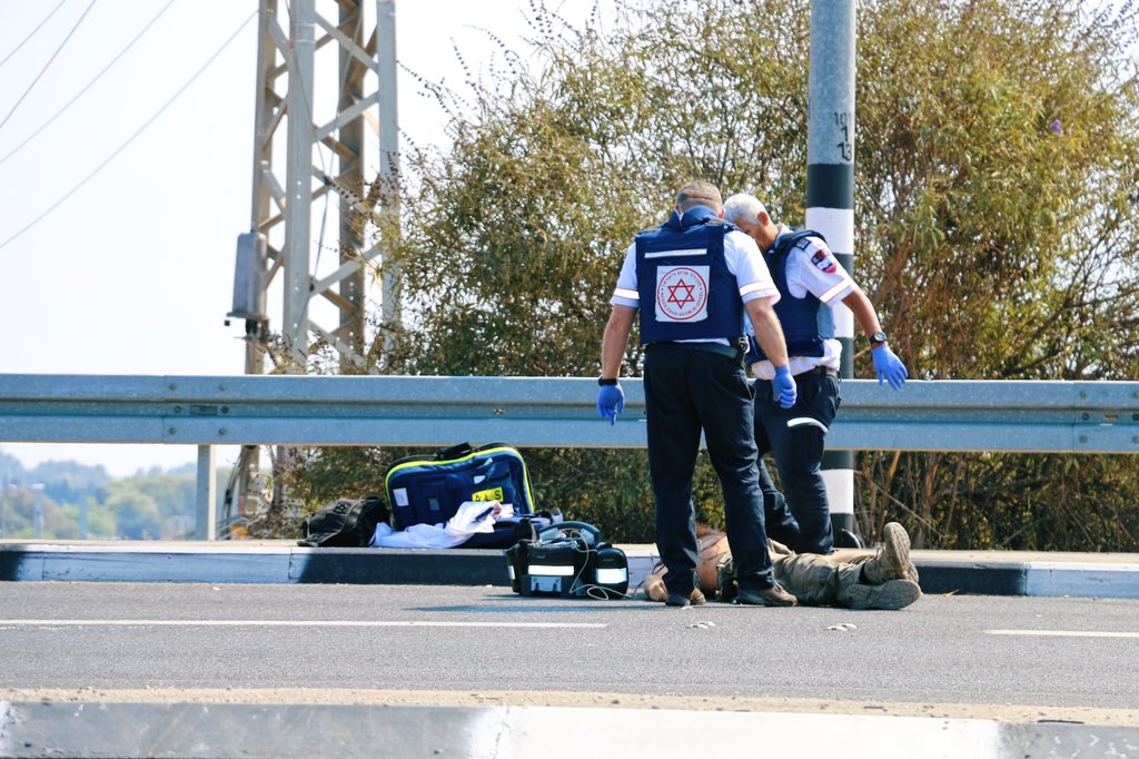 TreyYingst's tweet photo. Warning: Disturbing photos

What I saw in southern Israel today. 

1. Paramedics declare an Israeli soldier dead after trying to revive him.

2. Plumes of smoke rise from the horizon after direct rocket hits.

3. The body of a Palestinian militant is covered in foil.

4. Israeli soldiers prepare their gear after arriving at the Gaza border.