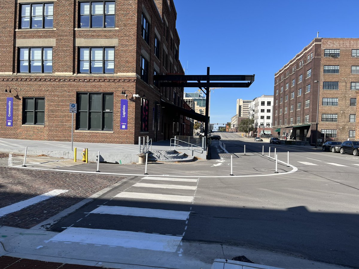 jbragg89's tweet photo. @GATOmahaNE Stopped by the downtown library today and noticed that the city has added a flex post protected on street pedestrian lane along the west side of 14th street. The turning radius around the corner has also been improved and the crossing distance has been reduced. https://t.co/DTN9d6apQU