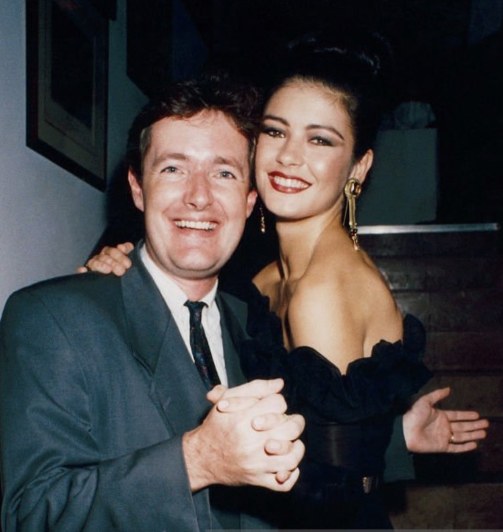piersmorgan's tweet photo. It’s been 30 years since I last posed for a snap with Catherine Zeta-Jones and it’s fair to see she’s aged spectacularly better than me. She was just as natural and funny as I remembered, and her singing later at the @dunhilllinks gala dinner was brilliant. 👌 https://t.co/7nErK0tMtR