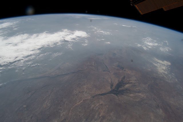 Okavango delta, #Botswana from #ISS. Image taken by <a href="/Astro_Andreas/">Andreas Mogensen</a> Extensive smoke from wild fires ravaging the region. 
Original eol.jsc.nasa.gov/SearchPhotos/p