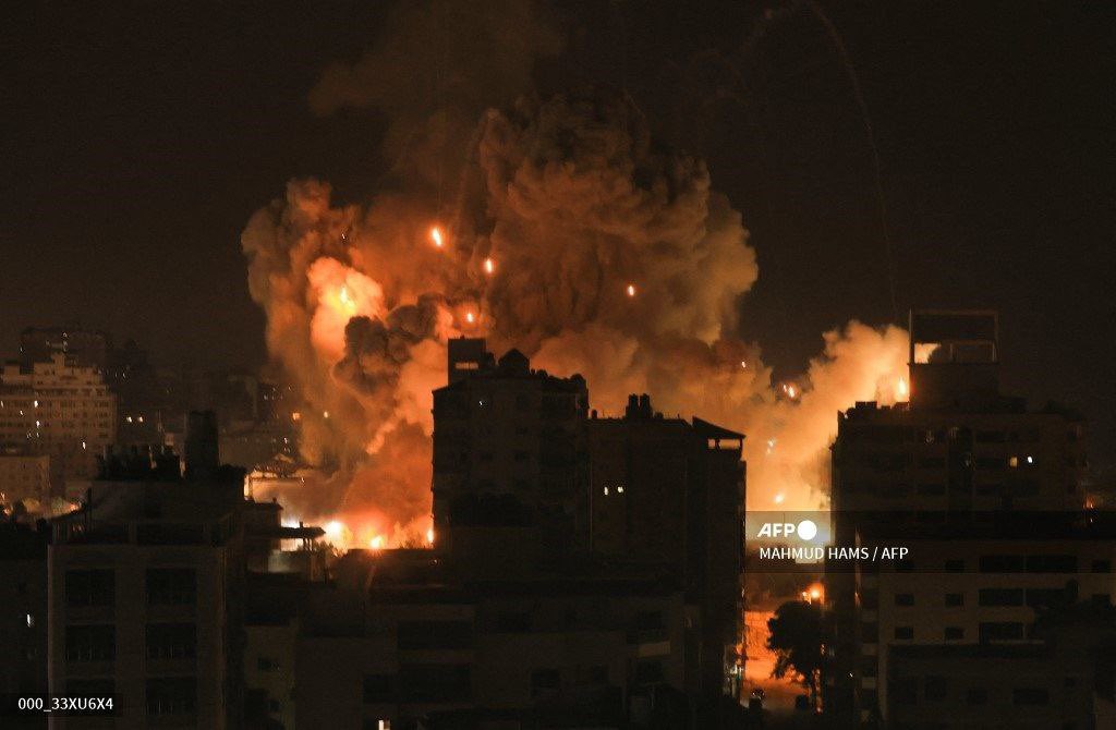 sentdefender's tweet photo. Massive Explosions seen in the “Majma' el Ansar” Sector of Western Gaza tonight following Israeli Airstrikes on a reported Weapons Stockpile used by Hamas. https://t.co/zMbbyanfrn