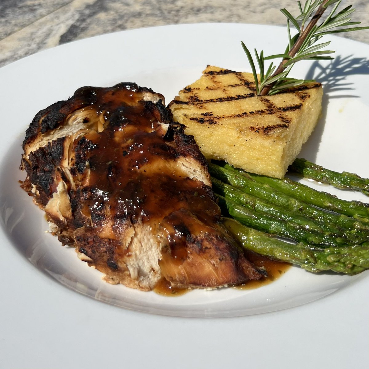 JT_Schmids's tweet photo. A symphony of taste and textures in one plate! 🙌 This week’s special features rosemary maple grilled chicken, a polenta cake, and butter poached asparagus. https://t.co/S0T3KgKCD6