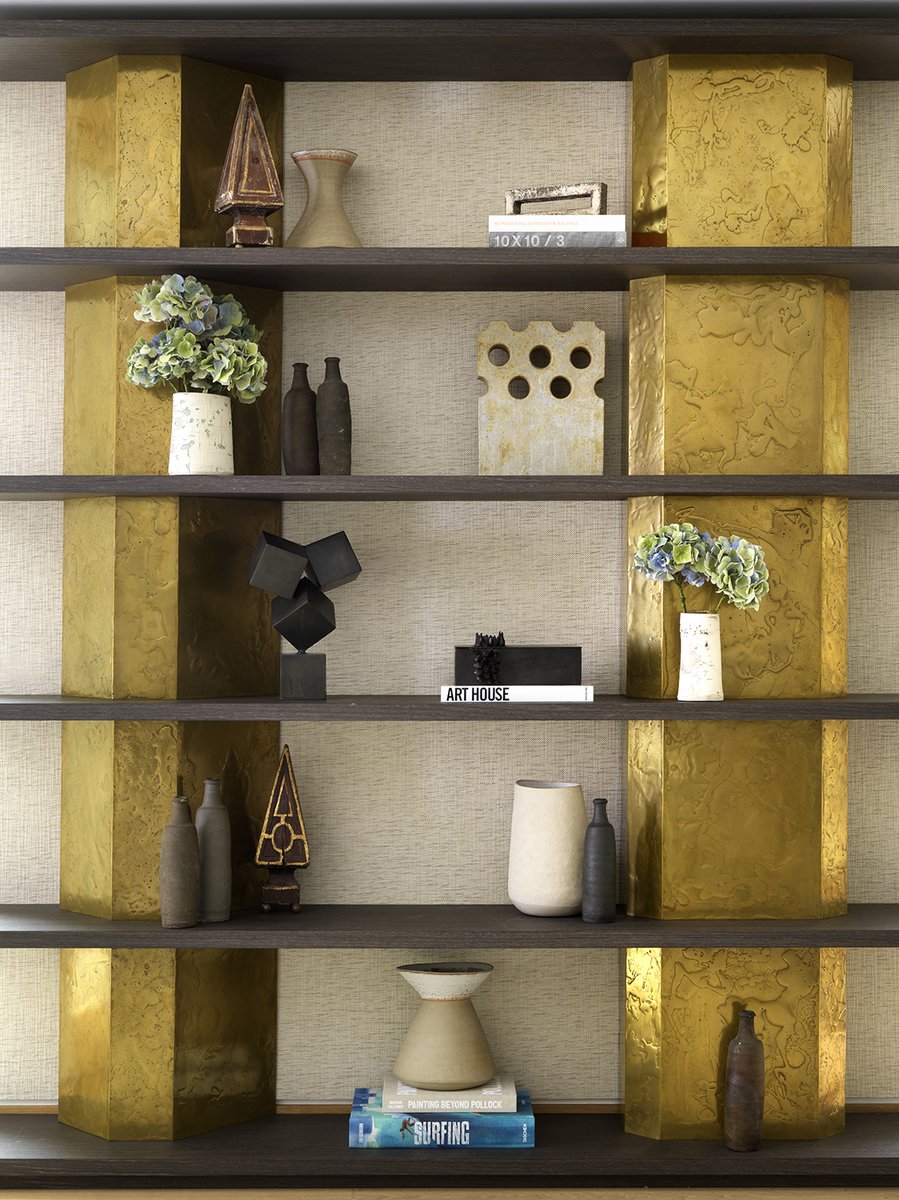 The asymmetrical columns with a liquefied bronze-gold finish and textured timber shelfs create a one-of-a-kind piece for a London apartment. A collection of artisanal ceramics in neutral tones, made by British crafters, is an effective contrast.