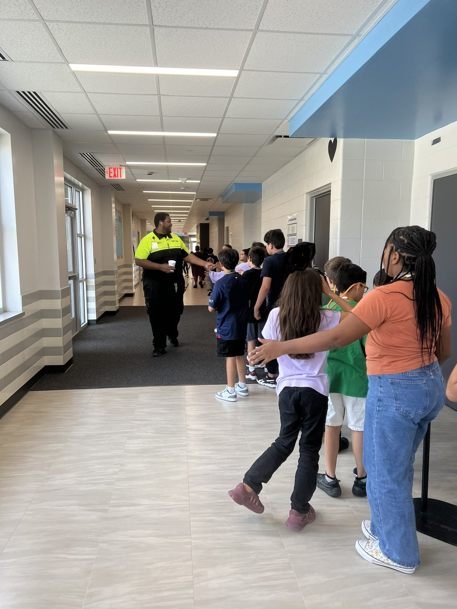 5th graders love sharing high fives or fist bumps with Officer Eric. <a href="/OLE_Leopards/">Leonard Elementary</a>