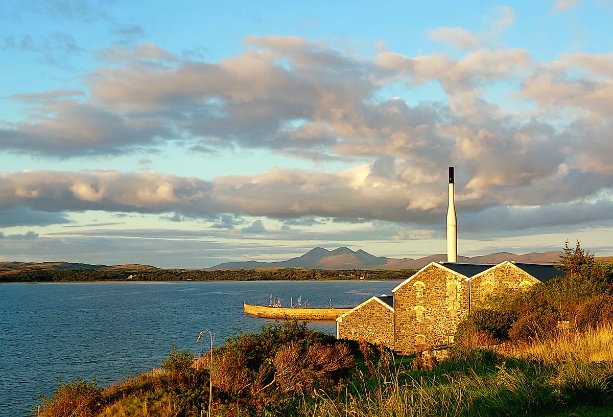 Golden evening light across the loch looking east towards Jura from Bowmore. Isle of Islay.