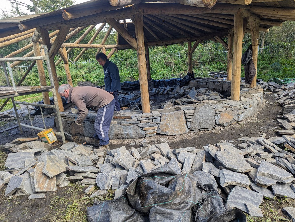Our beautiful reciprocal frame roof is almost fully boarded now, and the dry stone part of the wall is looking incredible. It's such a pleasure seeing this project come to life.  Time to start booking in more school sessions next!  #celtiaidcwmcynon <a href="/CCreadigol/">Cymoedd Creadigol</a> <a href="/CynonOrganic/">Cynon Valley Organic Adventures</a>