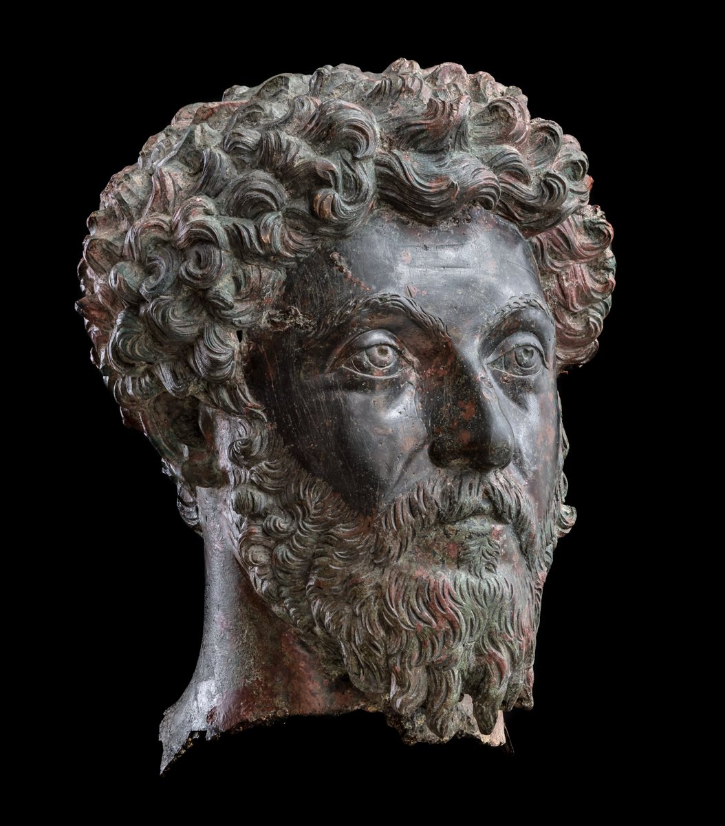 OptimoPrincipi's tweet photo. Bronze head of the emperor Marcus Aurelius, found in the Roman fort at Dunaszekcső (ancient Lugio) on the banks of the Hungarian Danube. The head was originally part of a full-length statue of the emperor erected in a central building of the fort, and likely a focus for the soldiers' veneration of the imperial cult. While the portrait is rightly regarded as a masterpiece of Roman bronze sculpture, it is probably representative of the imperial statues that stood in most, if not all, of the Roman camps along the embattled Danube frontier – guarded by no less than 7 legionary fortresses and 120 auxiliary forts. c.161-169 AD, Janus Pannonius Museum, Hungary.