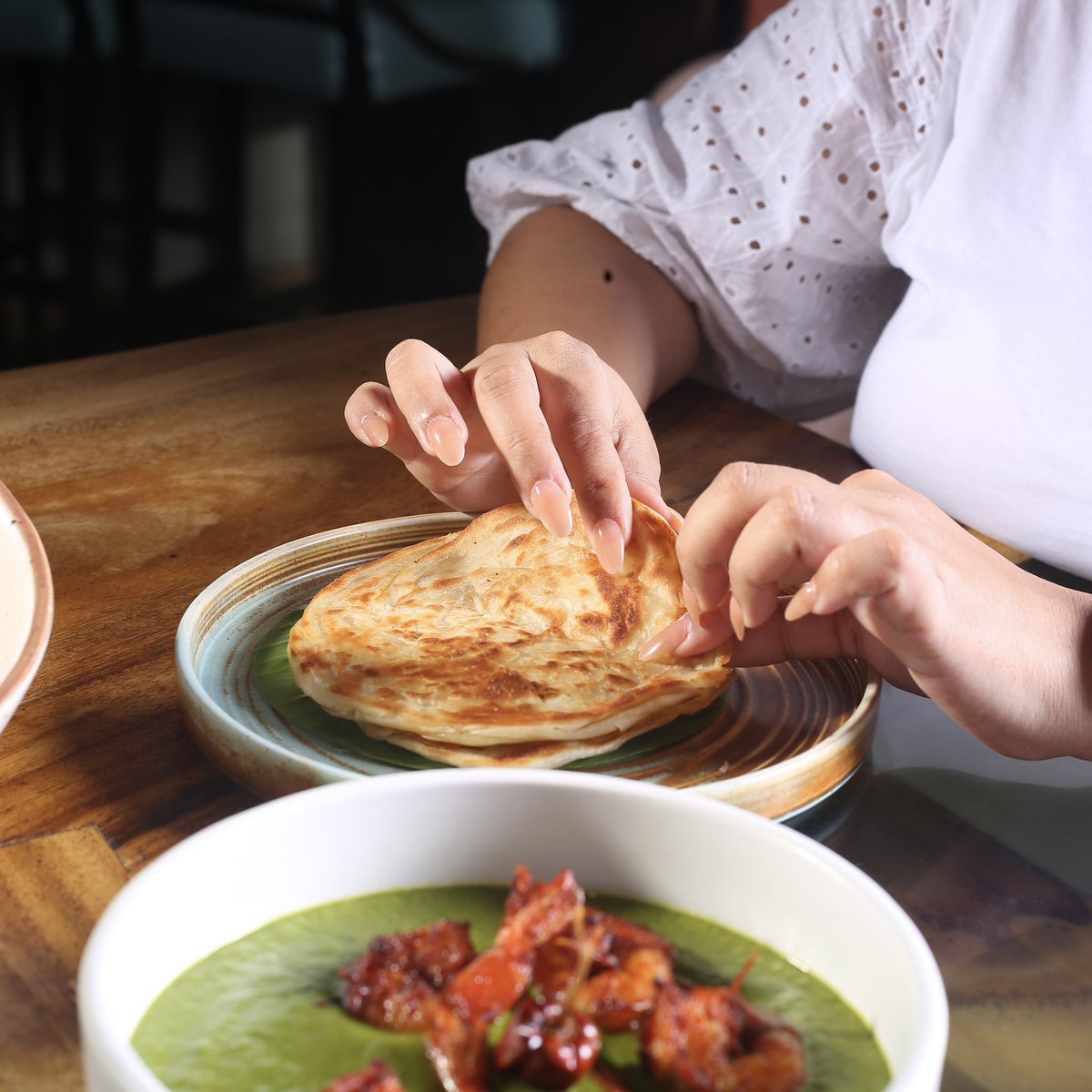 comorin_in's tweet photo. Dive into the rich tapestry of Indian regional food with the delectable pairing of our Nilgiri Masala Prawns with Malabar Parotta 🍽

The flaky layers of the parotta lend the perfect bite to our flavourful curry, making each bite irresistible.

#ComeOnIn https://t.co/OxctIUM47t