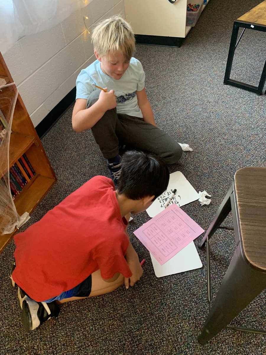 Working with partners to play addition tic-tac-toe.