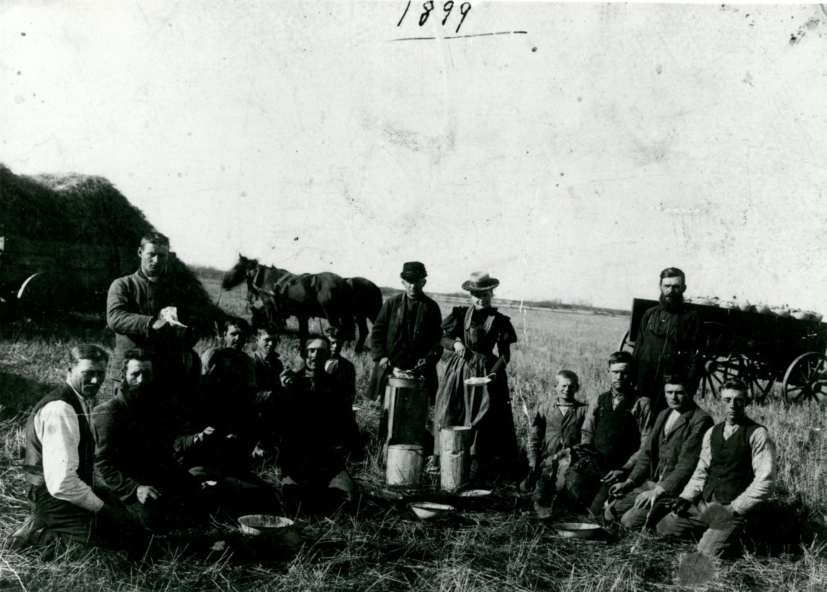 ProvArchivesSK's tweet photo. Harvest is a time for friends, family, &amp; community to come together.

This photo from 1899 is of a threshing crew taking a lunch break together (S-B4596). There appears to be a wagon of bagged grain &amp; a straw blowpile with possibly a portion of the threshing machine visible. https://t.co/JbMtKrISiG