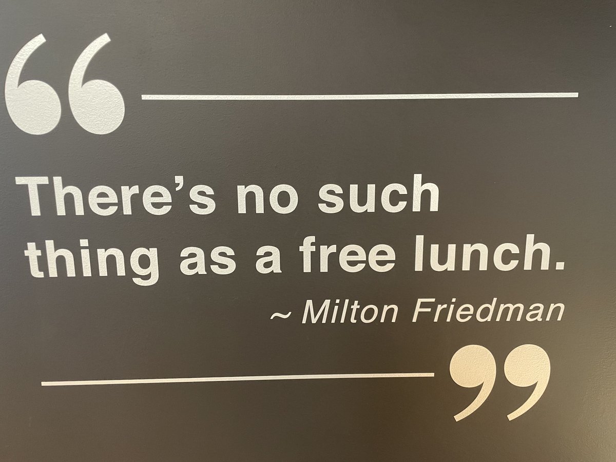 VanceGinn's tweet image. One of Friedman’s 🐐 best quotes is posted on the wall of the Freedom Embassy in Lansing, Michigan! @MackinacCenter #NothingIsFree