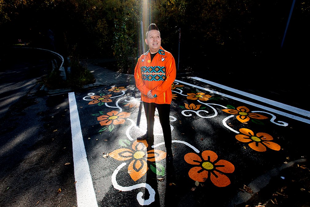 Artist @lancecardinal75 poses for a photo with the crosswalk he created titled 'Resilience' in honour of the National Day of Truth and Reconciliation, along Queen Elizabeth Park Road in #yeg Thursday. #nationaldayfortruthandreconciliation