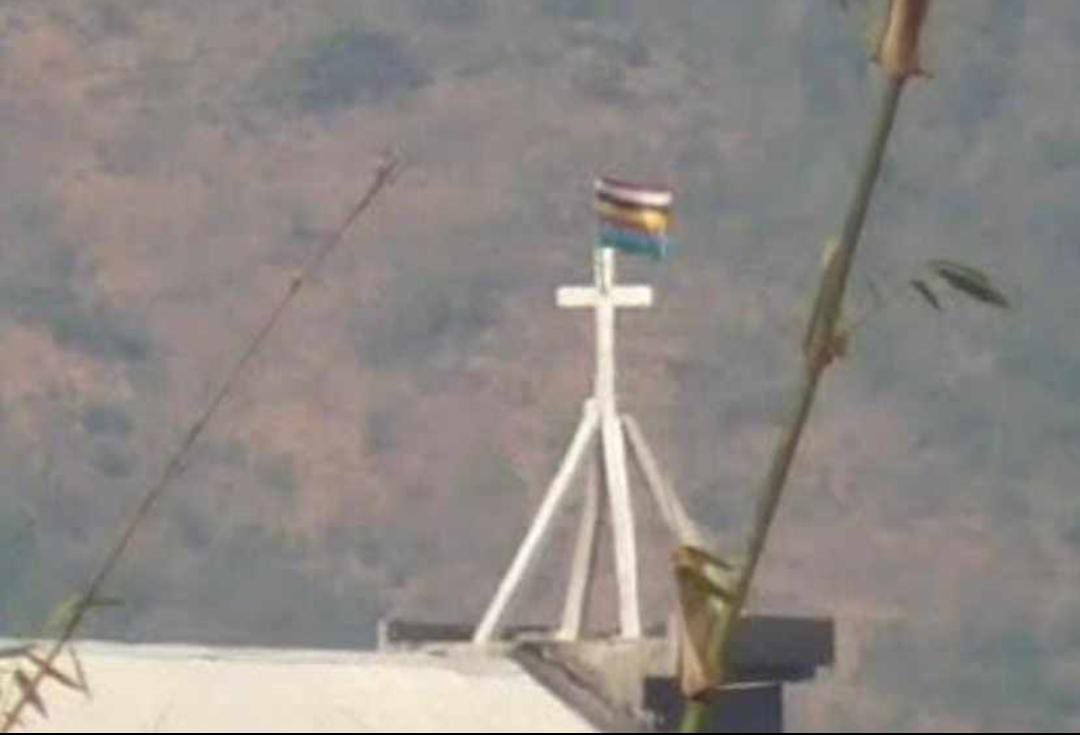 tebawk's tweet photo. They believed that vandalizing Kuki churches wasn't enough, so they opted to raise the Salai Taret Meitei Supremacist Flag above the Church, symbolizing their perceived superiority. The lasting impact of this act by the Meitei community will be remembered for generations to come. https://t.co/1gnHHUrD4e