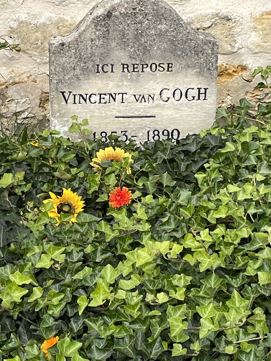 At the grave of Vincent Van Gogh in France. Covered with ivy and sunflowers, of course. #vangogh