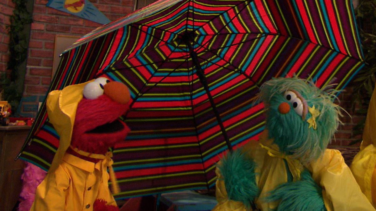 elmo's tweet photo. Elmo is under @Rositasesame's umbrella- ella-ella, eh, eh, eh! 🌧️☂️😂 https://t.co/S4lfnHftF4