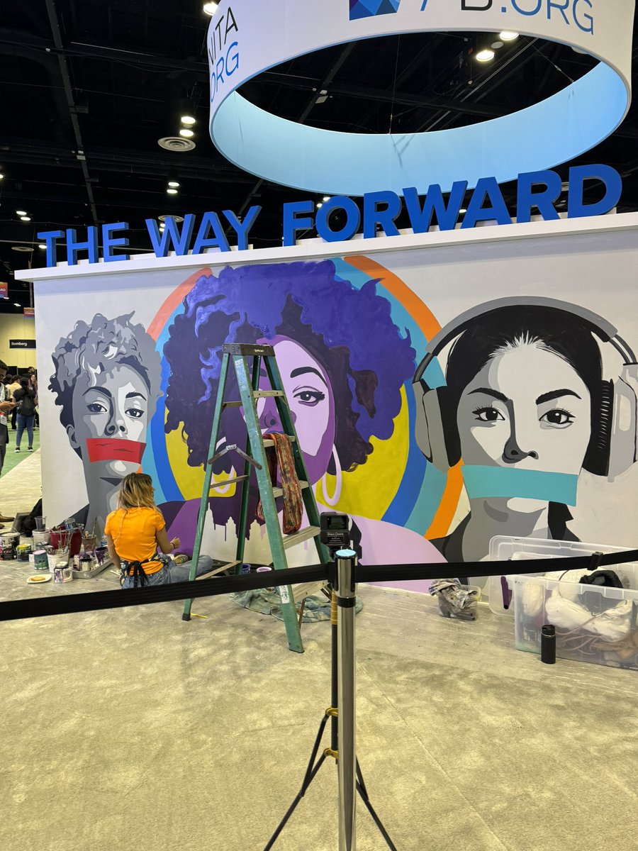 Olivia Stafne live painting a mural at #GHC23 at the career expo. It represents what it means to be silenced and what it means to be able to use your voice.