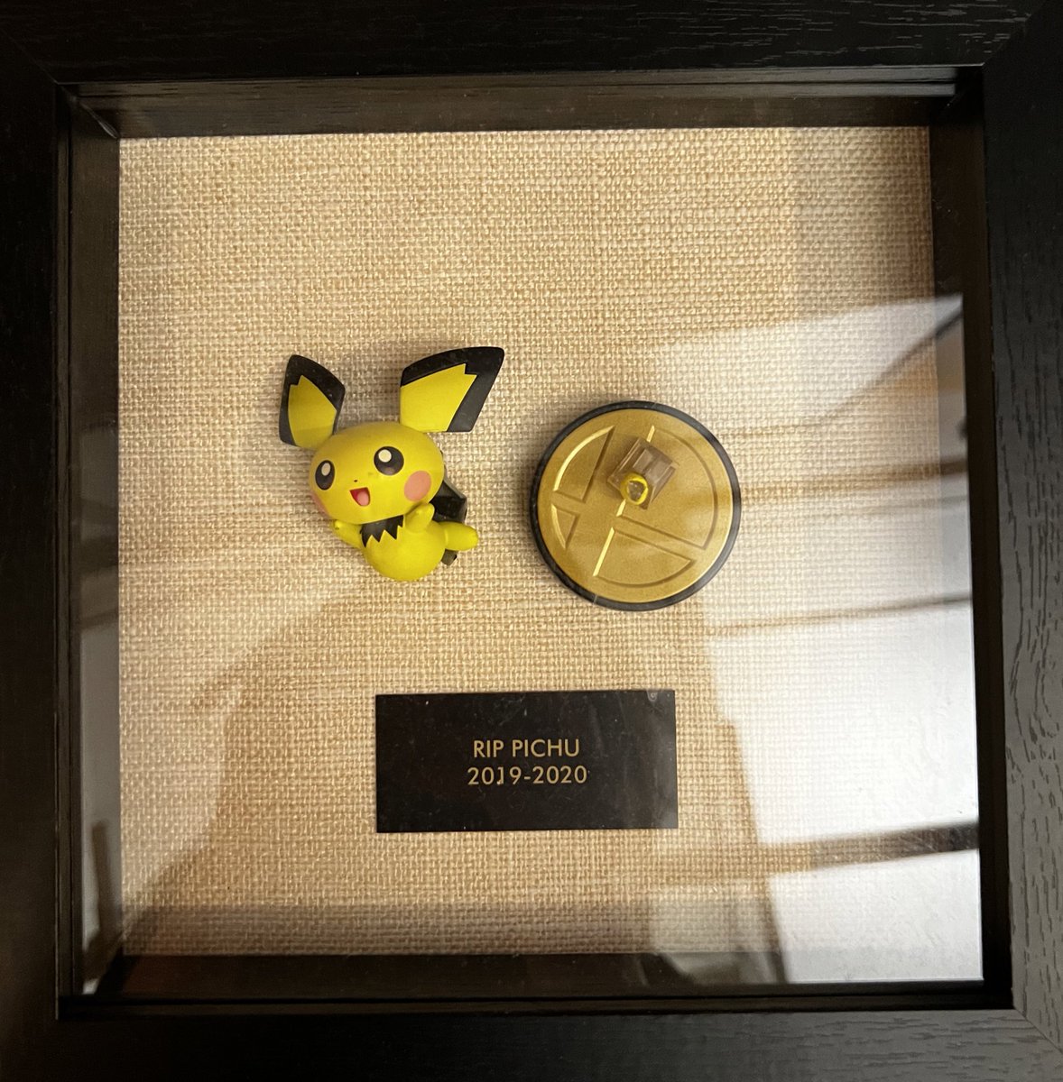 Found this in NY office, Pichu with its broken leg 😂 whoever framed this must a fan of Pokémon