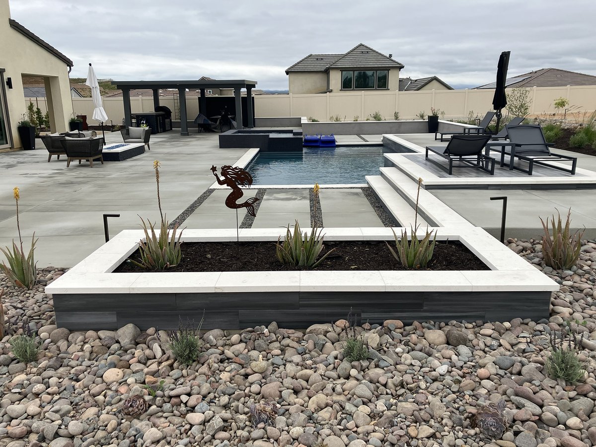 Looking for smooth, clean lines? How about cool, simple colors? Maybe some smooth, round pebbles? Then this week's modern landscape inspo is for you! #McCabesLandscape #modernlandscape #landscapedesign #outdoordesign