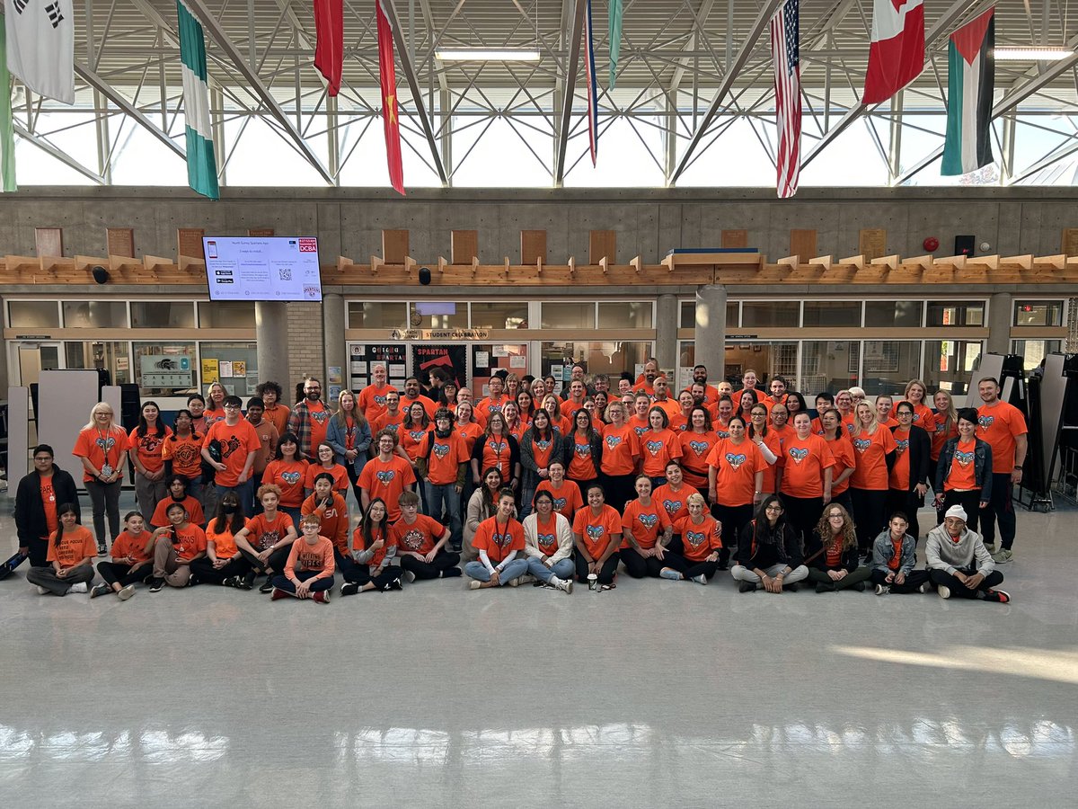 MsRacanelli's tweet photo. Truth and Reconciliation/Orange Shirt Day is not only a day of reflection, understanding and grieving, but about the work that everybody needs to do daily. Thank you to Layla Roberts, a @NorthSurreySec student, who designed our staff t-shirts. 🙏🏻 🧡@Surrey_Schools @Di_Christensen https://t.co/yFTRznjob5