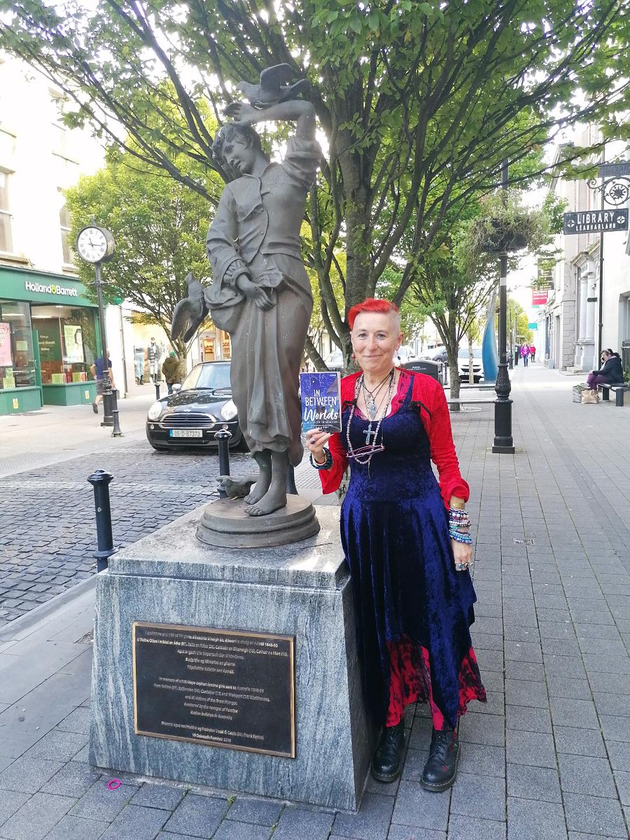 NicolaPierce3's tweet photo. Proudly holding up my novel, about the young Famine Girls who sailed off to Australia, beside the monument to them outside Ballina Library. Just a flying visit but I hope to return very soon. Thank you @MayoLibrary for a wonderful two days! @OBrienPress https://t.co/SuPLqtUHUB