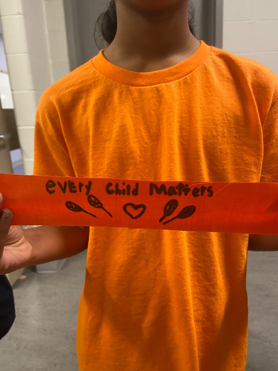 MissMajor21's tweet photo. Our Grade 3’s honouring Orange Shirt Day and recognizing that every child matters. Students wrote messages on their ribbons and tied them outside @stjbbruins . Today we pause and remember for Truth and Reconciliation 🧡 https://t.co/cZr3M5gHqJ
