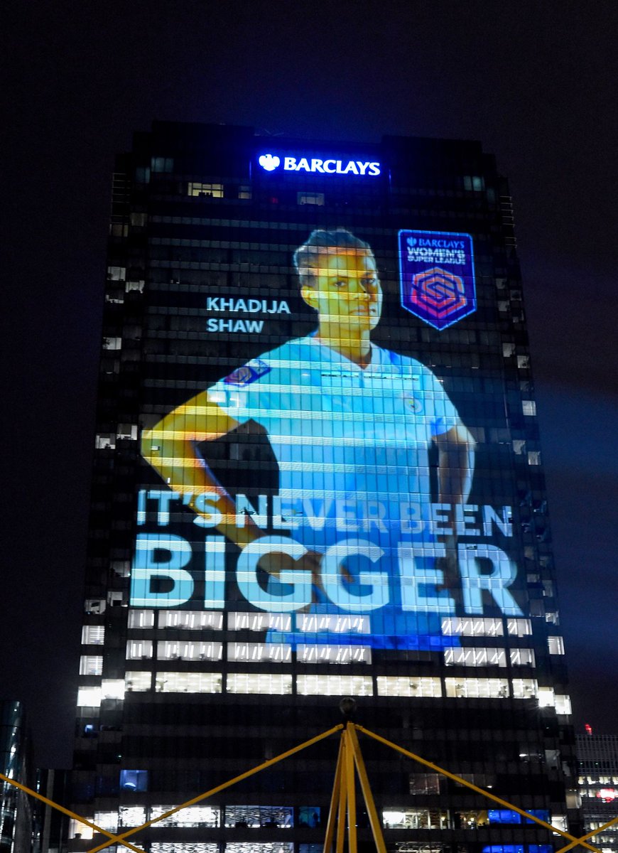 BarclaysCIB's tweet photo. Ahead of the match kicking off the 2023-2024 #BarclaysWSL ⚽ season, we lit up Barclays HQ in 📍 Canary Wharf with pictures of 12 female athletes, projected to 18 stories, honouring them as the giants that they are on the football pitch. https://t.co/QCargFWgCC