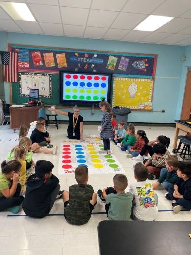 Grades K-4 students participated in their first "Coding Week" at John Street School with Ms. Caiazzo.  Pictured are Ms. DiCerbo/Mrs. Fox's and Mrs. Soupios/Mrs. Constantino's classes enjoying "Twister Coding"!