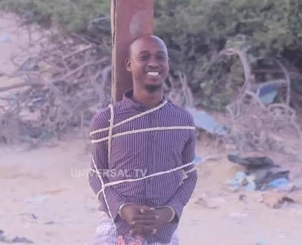StratCorpGlobal's tweet photo. HOW SOMALI INTELLIGENCE CAPTURED COMMANDER OF ASSASINS UNIT IN MOGADISHU 

January 01, 2020 

Voice of America 

A college teacher who is the son of a senior police officer has been found guilty of leading al-Shabab's operations in Mogadishu for several years.

Prosecutors wanted to file charges connecting Ahmed to the death of more than 180 people. 

In a video recorded and released by the court, Ahmed confessed to working as head of operations for al-Shabab in Mogadishu.

"I was head of operation of the city, the region," he said in the video. "There was nothing more nerve-wracking than sending out someone to do something…what will happen to them? Have they been killed?"

He said after an operation, al-Shabab bosses would call him to learn details about how it went, who fired the shots, and how many bullets were fired.

He would also send information to al-Shabab's radio station, Radio Andalus, so the group could claim responsibility for attacks and use it as propaganda.

The hunt

Ahmed, 27, from Bulomarer town in the Lower Shabelle region, has used multiple aliases over the years to evade authorities.

Somali security forces said they have been hearing his name since 2014, when al-Shabab suspects arrested for carrying pistols in Mogadishu's Hamarweyne district said a man they identified as "Hudeyfi" gave them the guns to carry out assassinations. The following year, more detained al-Shabab suspects mentioned the same name.

In January 2016, authorities arrested a man whose phone they had tracked because of contacts with known al-Shabab figures. He told the court he was a college teacher, which was verified, and he was released on bail. At the time, the officials did not realize that the man they arrested, Ahmed, was indeed Hudeyfi.

Over the following years, Ahmed used several other aliases. On November 2, 2016, a traditional elder was killed in Mogadishu. Two men arrested by the police in connection with the killing named their supervisor as "Dahir."

On December 2018, twin blasts near the National Theater in Mogadishu killed at least ten people including prominent television journalist Awil Dahir Salad. The two men captured in connection with the bombing named "Ilkacase" as co-conspirator.

Police have since established that Hudeyfi, Dahir, Ilkacase and Ahmed are the same person. On Tuesday, Ahmed confirmed this information to the court.

"I was originally known as Hudeyfi, but I worked with different groups and I gave a different name to each group," he said.

On Tuesday, Ahmed was convicted for the murder of police corporal Mohamed Omar Sheikh Osman, killed in a mosque on February 24 2017; the assassination of military General Abdullahi Mohamed Sheikh Qururuh, killed September 24, 2017; the assassination of Somali deputy attorney general Mohamed Abdirahman Mohamud on February 20, 2019; and the assassination of police General Mohamud Haji Alow on April 27, 2019.

He was also convicted for the assassination of police General Ismail Ahmed Osman on October 28, 2016. Ironically, Ahmed lived in Osman's house in the town of Marka when he was a high school student, after his father asked Osman to help his son, security officials say.

Military courts' prosecutor General Abdullahi Bule Kamey described Ahmed as a "merciless killer."
"His crimes are unmeasurable," General Kamey said. "He killed the man who raised him, the hand that fed him, General Ismail," Gen. Kamey said.

The prosecution said Ahmed spared his father's life only because he wanted to use him as a cover. "He let him live so that he bails him out when captured," Kamey said.

VOA Somali contacted an official at a Mogadishu college where Ahmed taught. The official, who asked that the college not be identified for fear of reprisal, says Ahmed taught English. The official says the college did not know about his connections with al-Shabab.

Ahmed was executed by firing squad in December 2020.