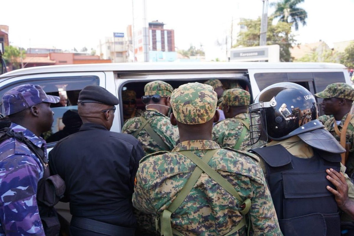 MathiasMpuuga's tweet photo. The military siege of our party headquarters & the arrest of our Secretary General @DavidLRubongoya and Spokesman @JoelSsenyonyi speaks volumes about our country's democratic credentials. 
This happening on a day when the country is supposedly celebrating its 61st Independence Day only shows that we are still under colonialism - it's only the colonisers skin colour that changed.