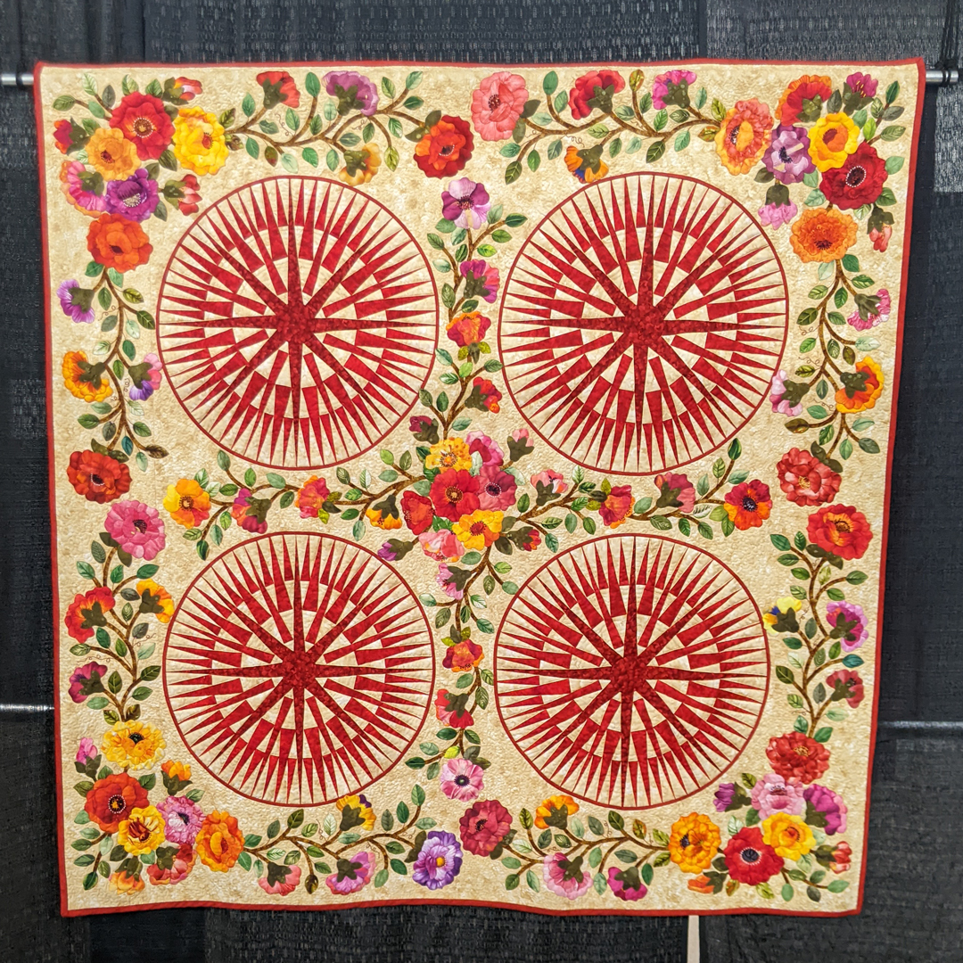 WIQuiltShow's tweet photo. "Rosie's Gardens," created and quilted by Rosillis Rosario of Las Vegas, Nevada, entered in the 2023 Quilt Contest, Wall Quilts, Machine Quilted - Pieced category. Design found in Quilter newsletter. #WisconsinQuiltShow https://t.co/cDoj4TdtgV