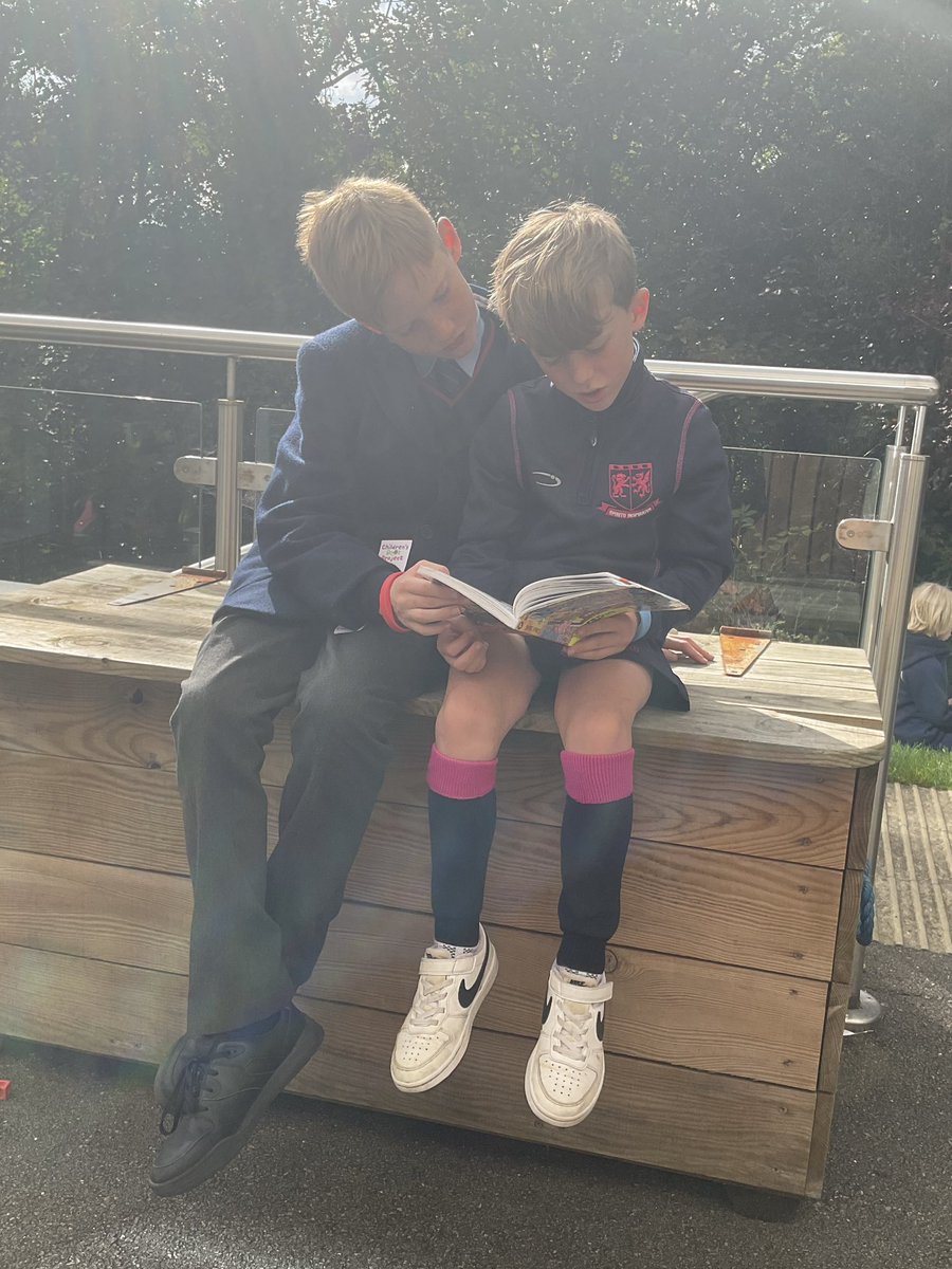 HWD_Upper's tweet photo. Year 7 are being brilliant role models as they meet up with their buddies from Year 3. Basking in the sun while reading some of their favourite books, it’s lovely to see these two year groups come together. #HazelwoodYear7 #HazelwoodYear3 #HazelwoodBuddies @HWD_Lower https://t.co/xmVihVEuex