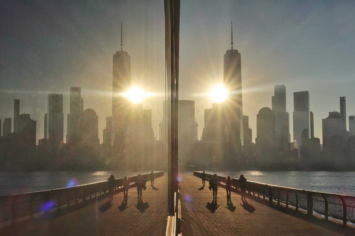 GaryHershorn's tweet photo. Wandering along the Hudson River in Jersey City, NJ as the sun rises in New York City, Wednesday morning #nyc #newyork #NewYorkCity #sunrise @empirestatebldg https://t.co/4ICCGaLdx4