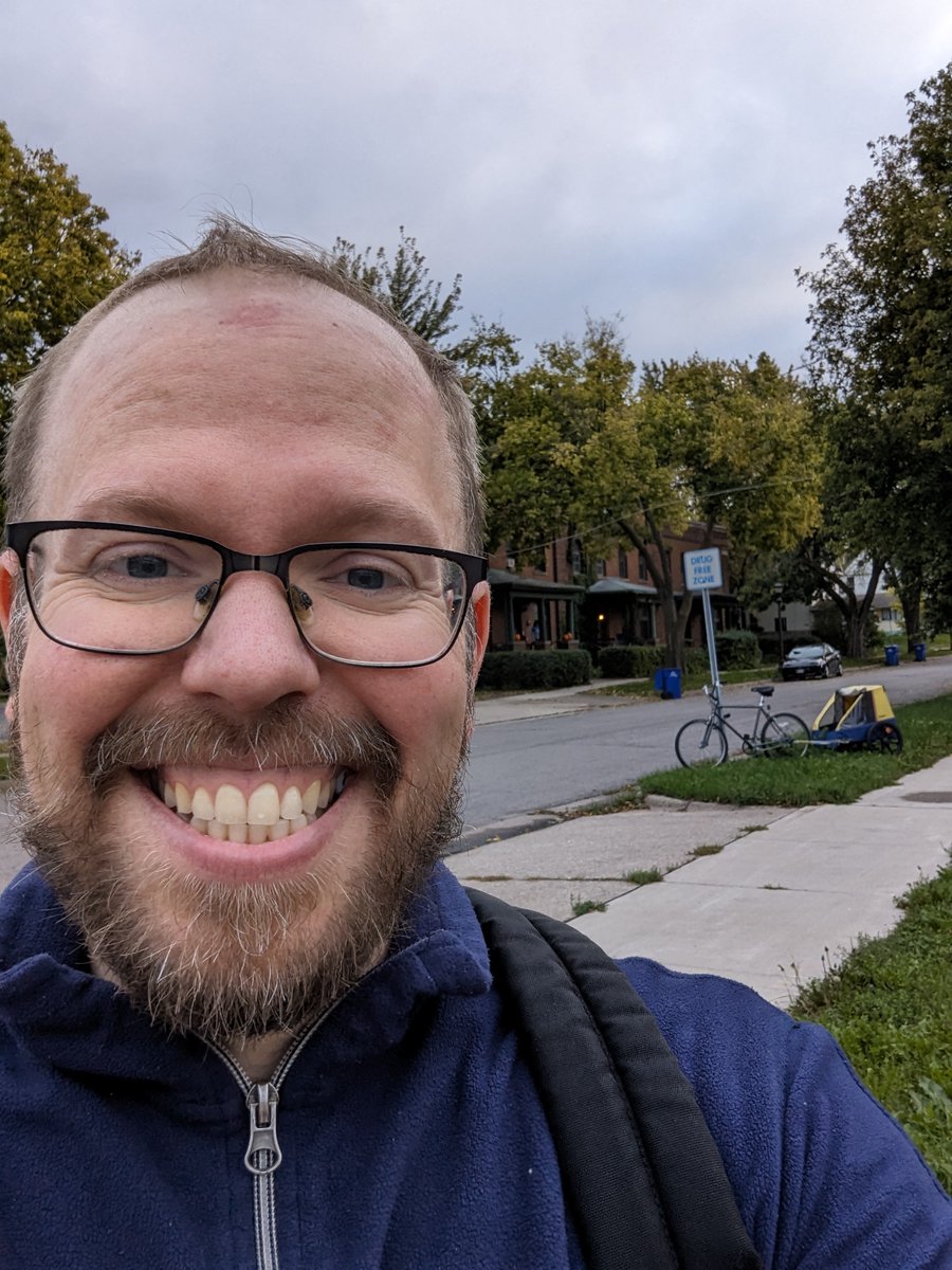Dropped off one kid at daycare, one kid at kindergarten for Minnesota's bike to school day! That's my burley in the background as I wait for the bus to work.