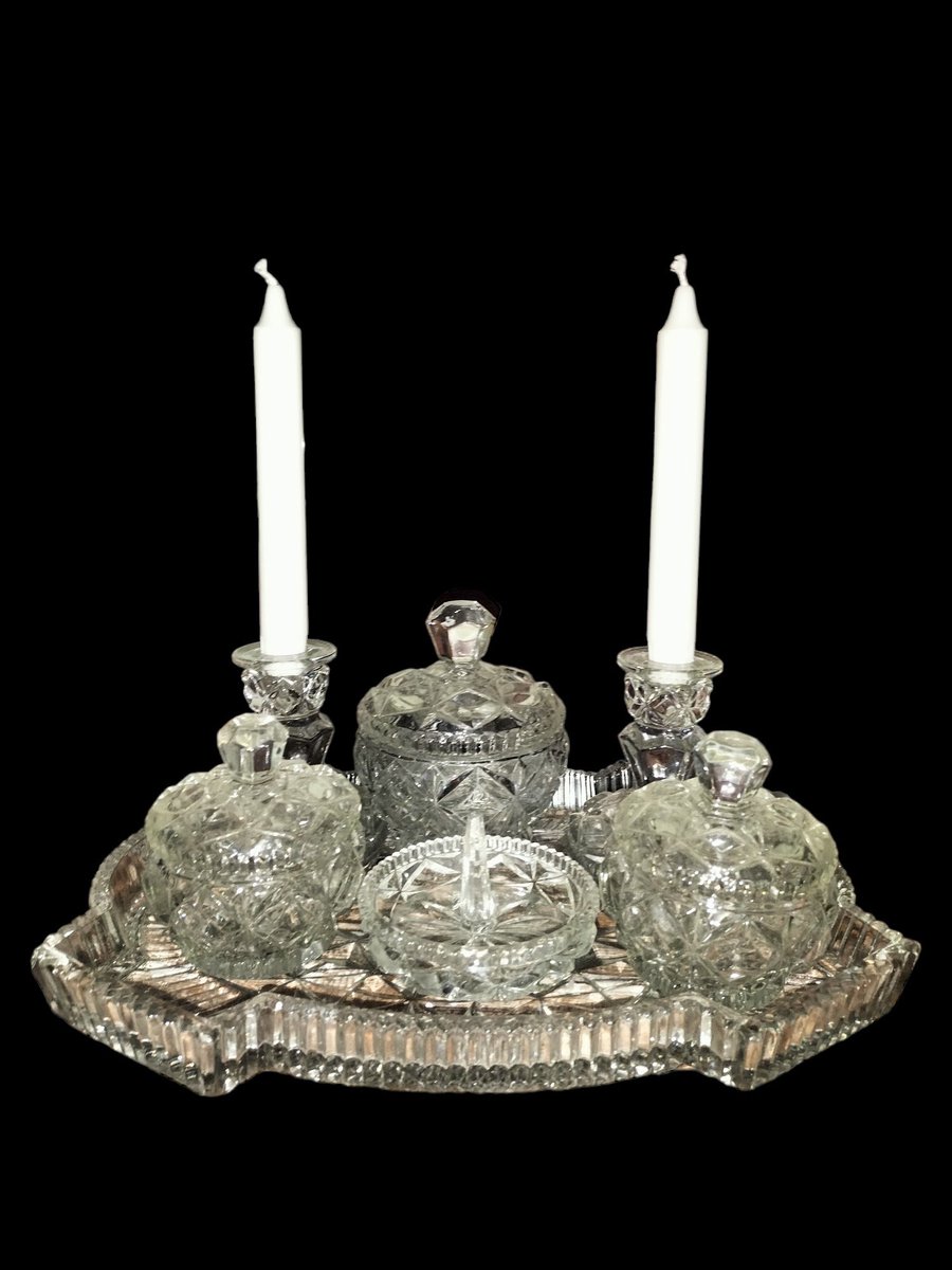 Treat yourself Transform your bedroom space with our stunning vintage glass vanity set. Sleek design, ample storage, and a touch of sophistication. 3 storage jars with lids 2 candle holders 1 ring holder All stored neatly on a lovely glass tray