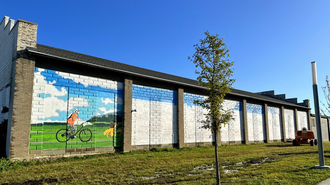 CityofCB's tweet photo. Local artist, Betni Kalk is making progress on her mural. This is called "Evolution of Transportation" and you can find it on the FIRST AVE facing wall at 15 S 20th St - about 1 block east of Cochran Park. #firstavecb #unleashcb https://t.co/vEXKcvzv4O