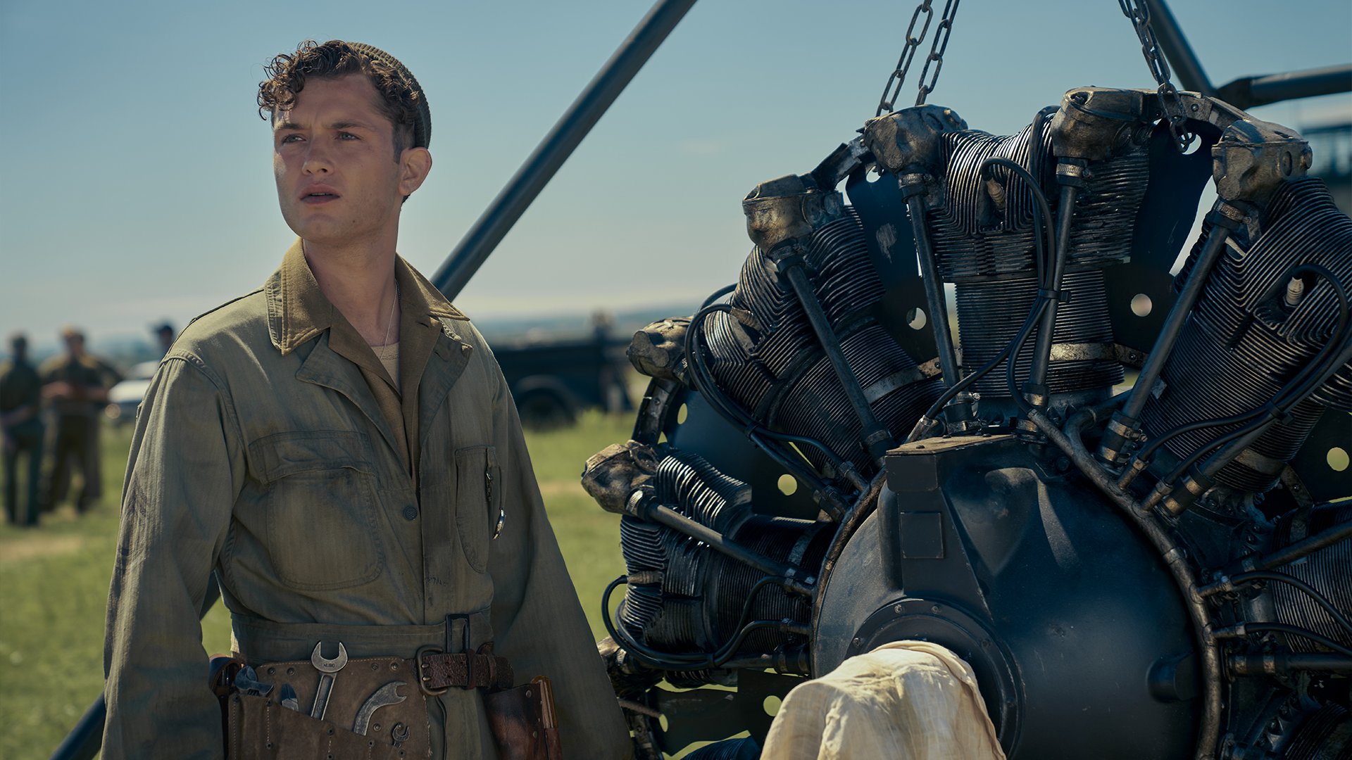 Raff Law as Ken Lemmons, standing near a B-17 part.