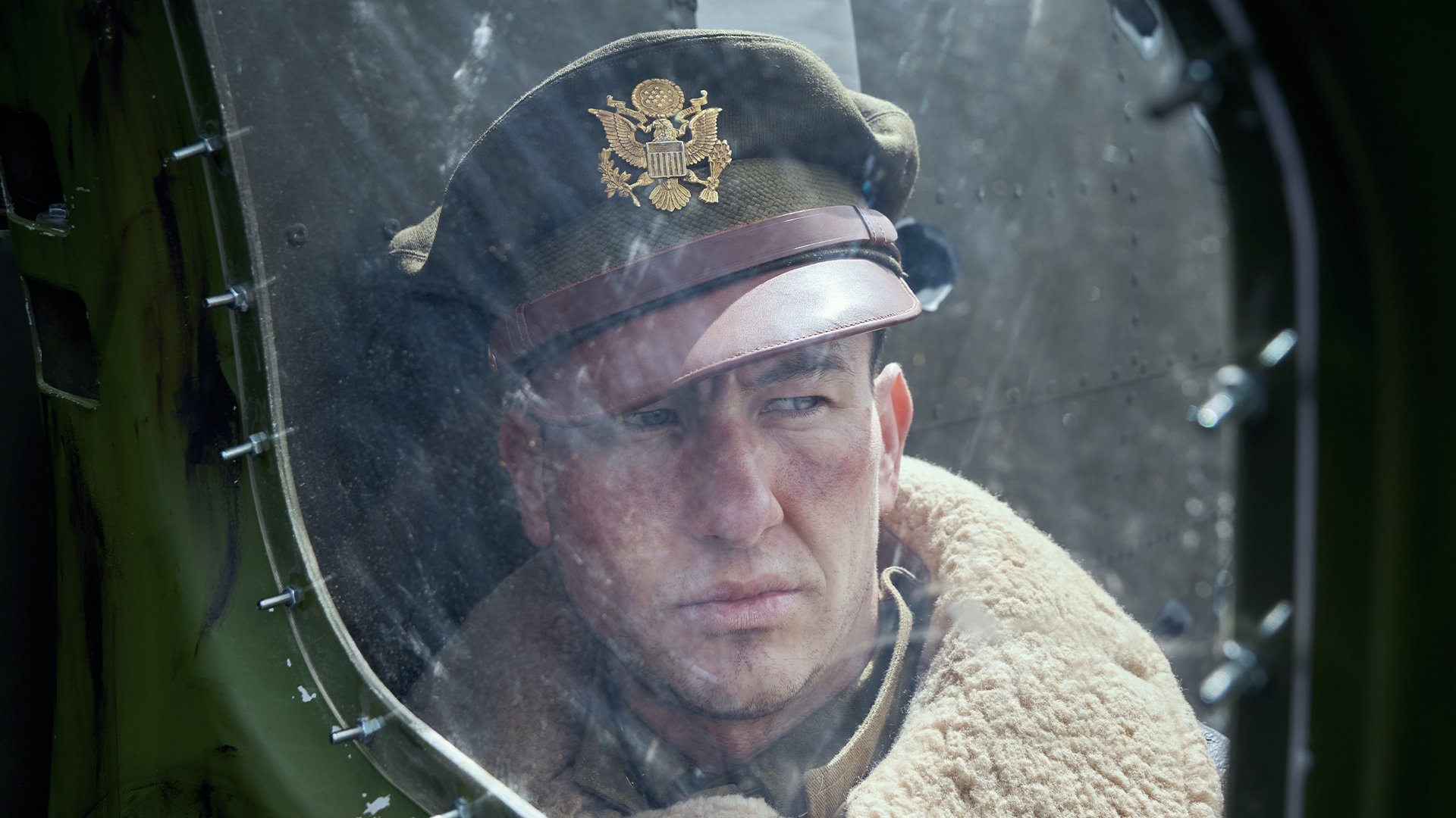 Barry Keoghan as Curtis Biddick smoldering through a B-17 window.
