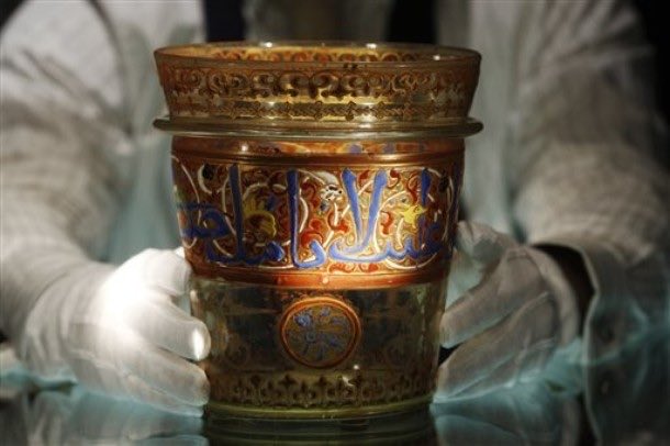 A rare 14th century Turkic-Mamluk glass bucket for the Sultans, decorated in gold and with animal figures.

The inscription is rather interesting, and it reads:

“I am a toy for the fingers shaped as a vessel. I contain cool water.'
