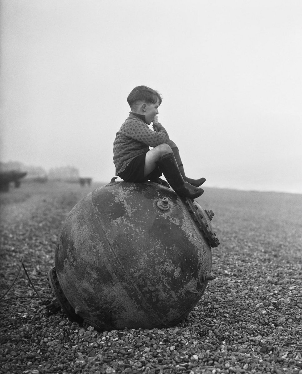 A young boy enjoying an ice cream, little does he know the danger of the washed up sea mine.

This photo was taken in the 40’s in my hometown Deal, Kent, UK.

#ww2 #blackandwhitephotography #1940s #dealkent