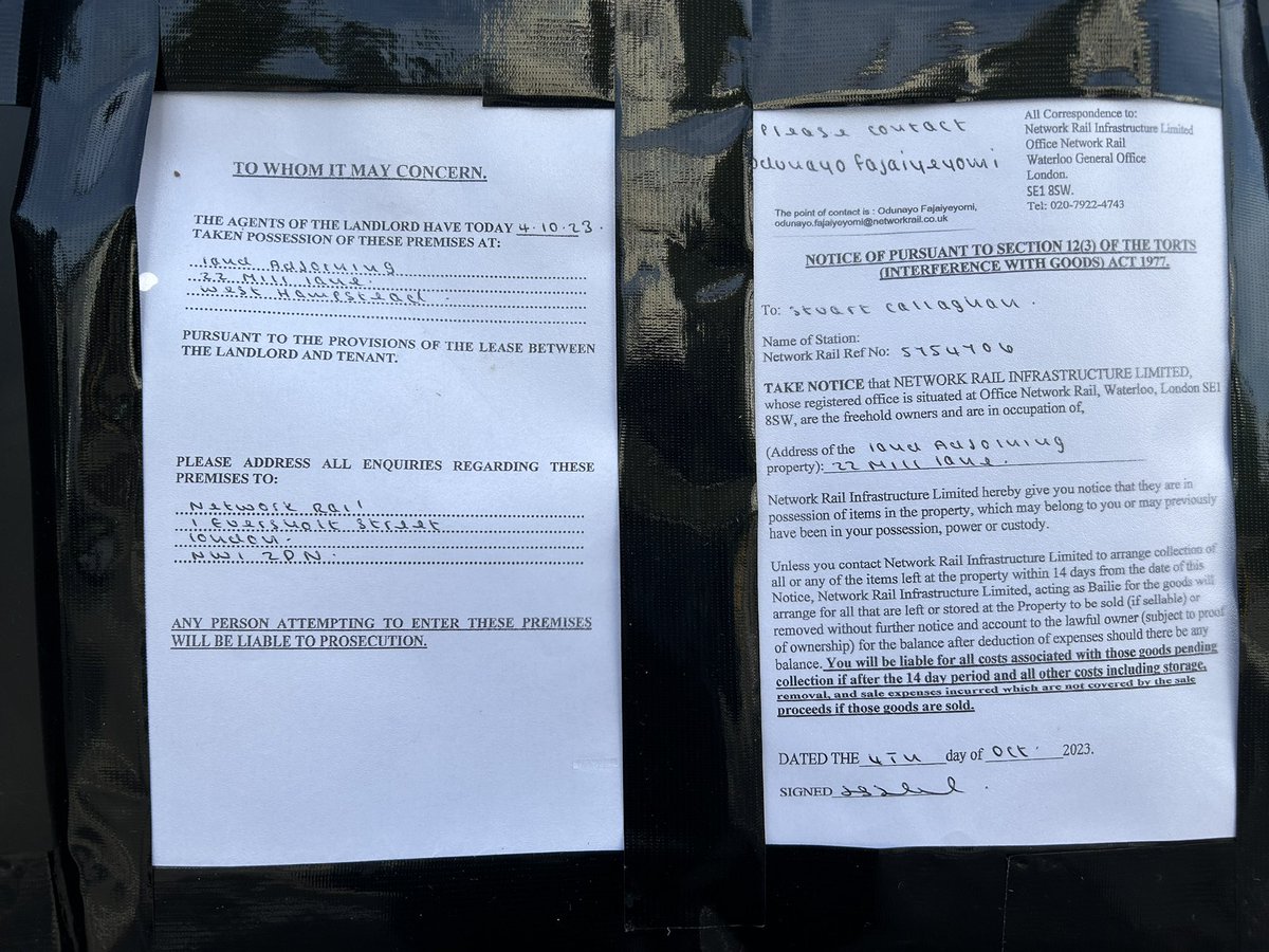 Large pile of dumped belongings behind the fence where the storage place on Mill Lane used to be.