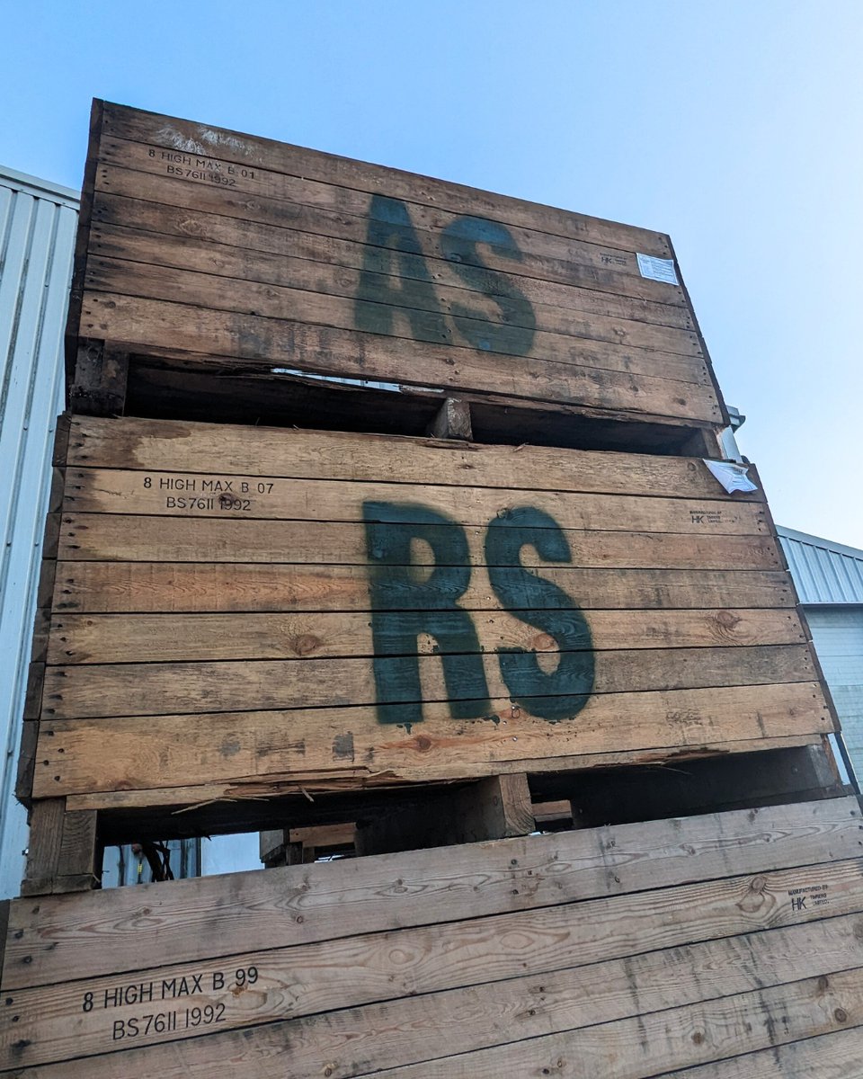 These might just look like potato boxes to you, but there's a really special one here! Every farmer stamps their boxes with their name - RS is for Robert Strathern, for example. Laura and Robert's son Angus helped on the farm all through summer and stencilled his own.