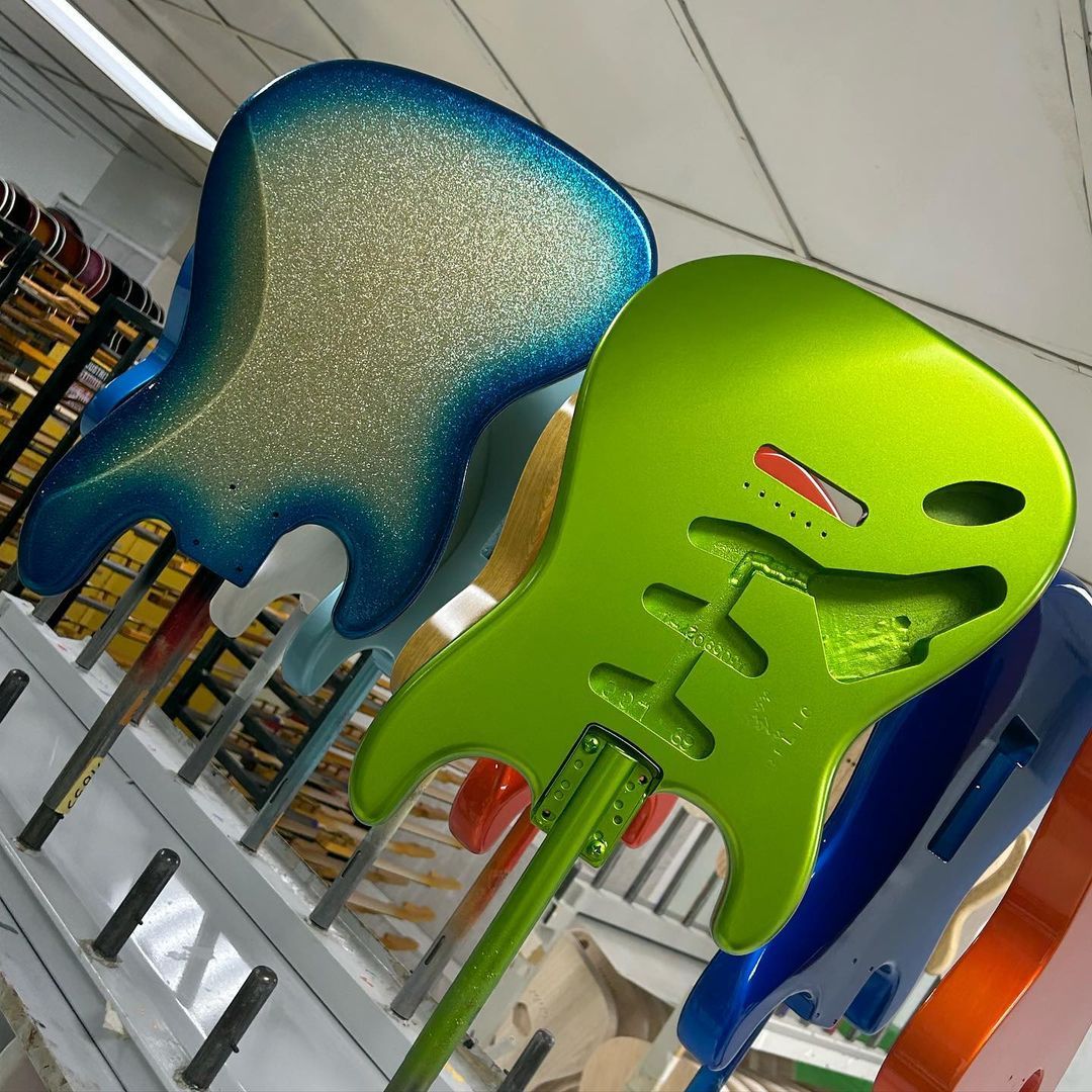 Fender's tweet photo. We're bringing a splash of color to your day with a Blue Sparkle Burst Jazz Bass and a Lefty Lime Green Strat — Built by Joel Lopez. Drop your favorite in the comments. https://t.co/0fmXp91wY7