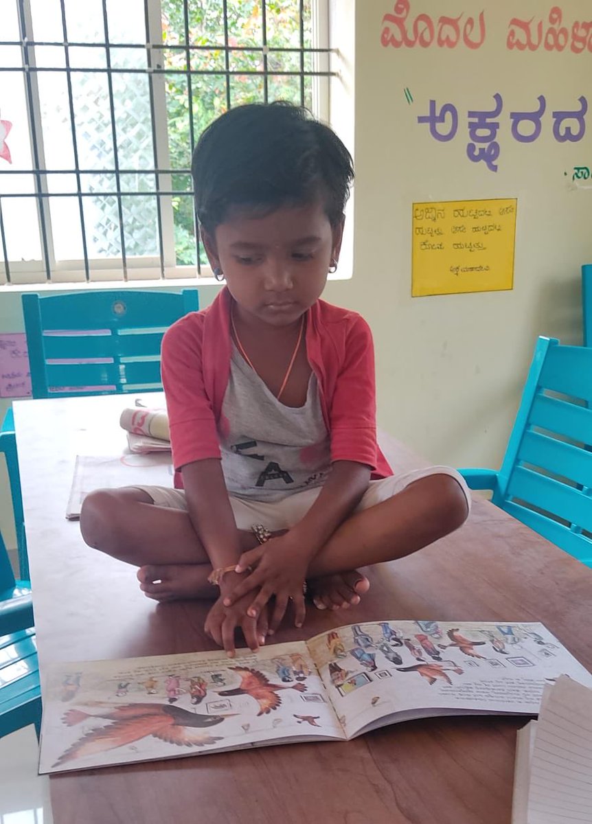Anganwadi child with a picture book in the rural library. #kidsinlibraries #learningtoread