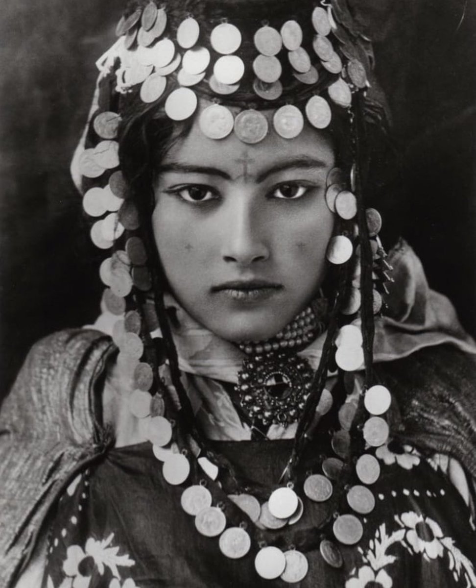 A young woman from the Ouled Nail (pronounced "willed nah-eel") tribe in Algeria, 1905.

The Ouled Nail origins are shrouded in mystery but some time in the 7th and 8th century, they converted to Islam along with the other Imazighen in North Africa. What distinguished the Ouled