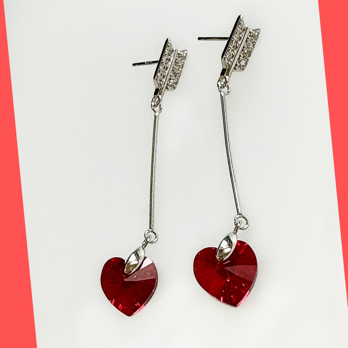 Sterling Silver Arrow Earring Studs with Red Swarovski Heart Crystal.  #swarovskiheartearrings #arrowearrings #sterlingsilverarrowearrings #silverarrowheartstuds #marjancreations