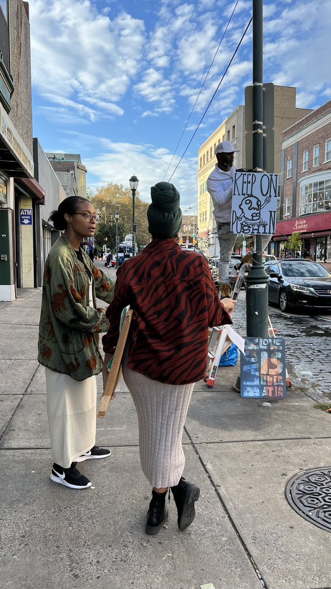 StreetsDept's tweet photo. In Germantown this afternoon with @CrownPubCo as they install the next iteration of their Afromation Avenue street sign project! Created with support from @muralarts. https://t.co/uecZJZUOOY