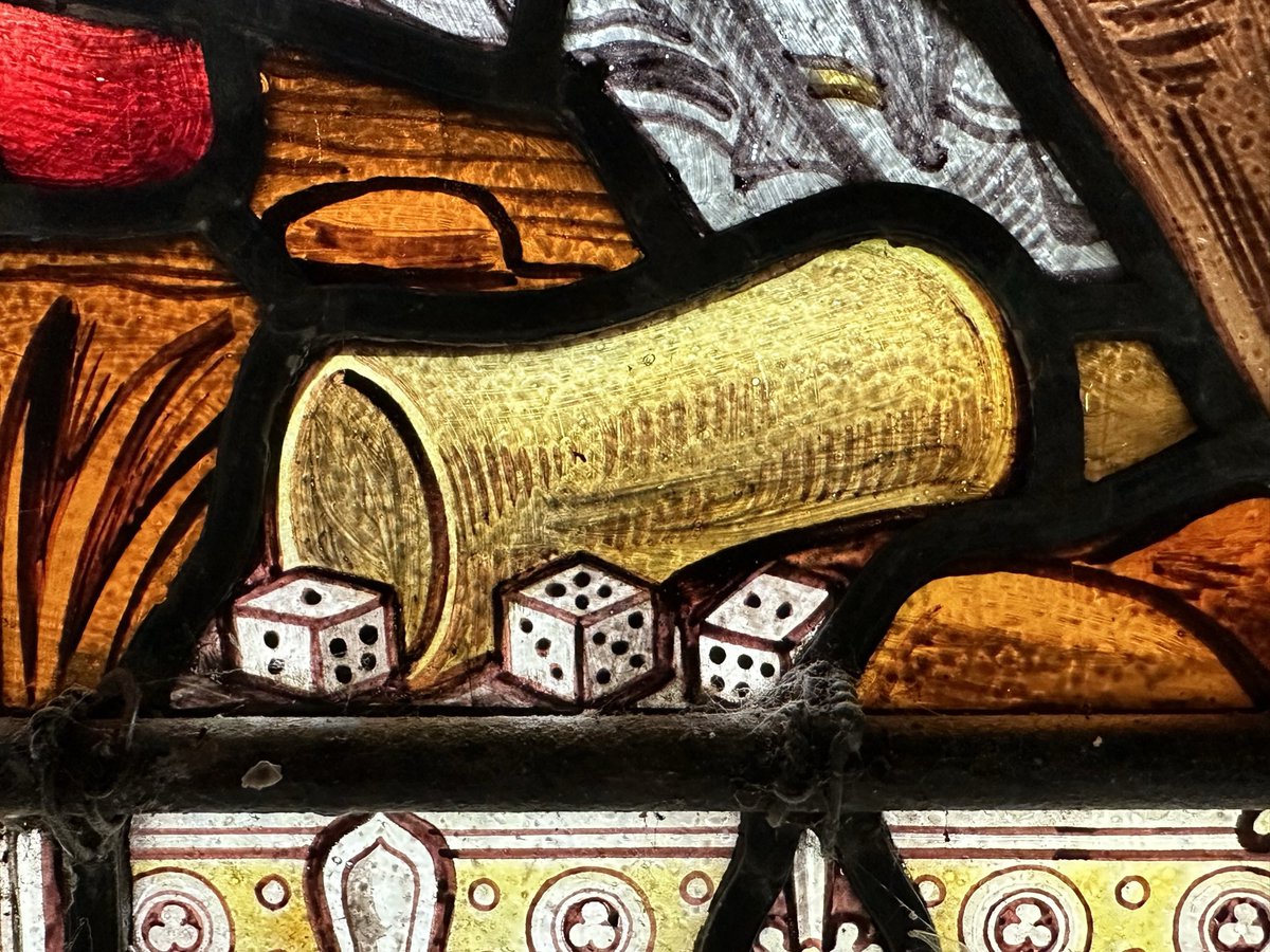Dice from the Passion story in stained glass at Llanishen church, Monmouthshire.