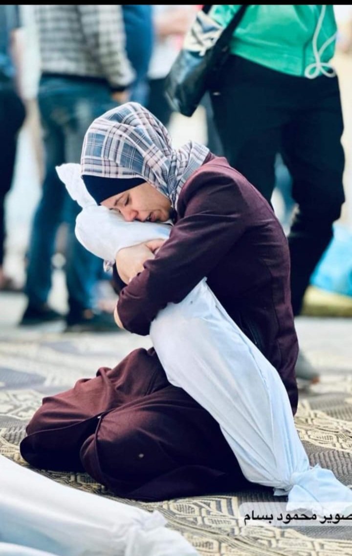 Fatema20d's tweet photo. This is our situation... The mother bids farewell to her martyr child, who was brutally killed by the unjust occupation planes in light of the silence of the international community.💔

Save the children  
Stop the war https://t.co/IQkt9BGghP